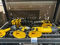 Overall view of Dewalt cordless tools including reciprocating saw, jigsaw, flashlight, cordless drill, impact driver, and charger.