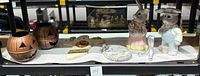 Lot displayed together showing all items including ceramic bunnies, Christmas plate, metal pumpkins, and wooden ghost.
