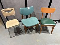 Photo showing all three chairs together: Scholar Craft plastic and metal chair, Thonet wooden and vinyl chair, Heywood-Wakefield upholstered chair.
