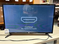 Front view of the Onn 32 inch Roku TV powered on showing 'No signal' message on screen.