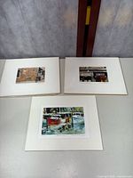 Three signed art prints shown mounted on white mats. Two smaller prints by William Hantuell and one larger print by Richard Ochs.