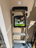 Front view of the 3-step aluminum step ladder showing the full frame and top handle.