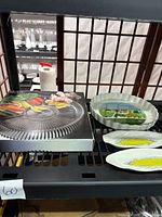 14-inch Mikasa divided platter in box, vintage Villeroy & Boch quiche dish with scene, and two ceramic corn plates on shelf