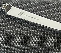 Close-up of one knife blade showing the inscription 'STRAWBRIDGE & CLOTHIER' and 'SHEFFIELD', indicating the brand and the origin of the stainless steel blade.