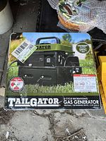 Box of Tailgator 2 Cycle Recreational Gas Generator showing front and side views with product details.