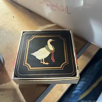 Closed coaster set box with goose design on top
