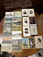 Table display of 13 vintage postcards featuring scenic views, landmarks, and landscapes from American states and regions as listed.