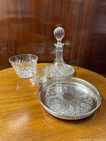 Overview of all items: Spode crystal decanter, Georgian crystal glass and ice bucket, silver plated brass gallery salver with intricate engraving and pierced rim.