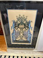 Framed artist proof print showing the full artwork with symmetrical natural and architectural elements, double matted in beige and blue mats, under glass.