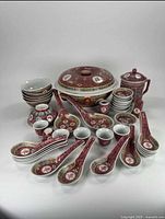 Complete set display showing all 39 porcelain dinnerware pieces including terrine, bowls, glasses, sauce containers, salt/pepper, spoons, and cup with lid.