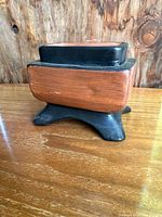 Side view of the planter showing the black top rim and base with reddish-brown middle