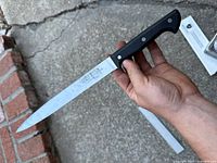 Front view of 10 inch Gerber Balance Plus slicing knife showing the blade with Gerber markings and slight surface rust spots.