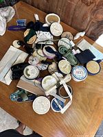 Photo showing various vintage sewing supplies arranged on a wooden surface including elastic bands, ribbons, measuring tapes, and sewing accessories.