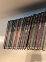 Side view of 18 hardcover books in the Great Ages of Man series, showing spines with titles in white or gold lettering on varying colored backgrounds.