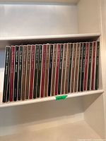 Books arranged on shelf, showing the full set of 30 volumes with uniform spines in maroon, green, black, and beige colors.