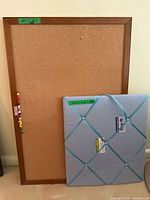 Traditional cork board with wooden frame featuring pushpins on left side with close-up showing size label 24" x 36".