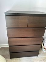 Front view of dark wood dresser showing 4 large drawers and 2 smaller top drawers, dark brown finish.