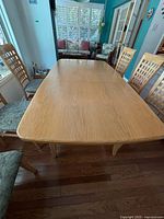 Overhead view of rectangular wood tabletop with two leaves installed
