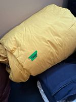 Yellow duvet with a green label reading 'Single'