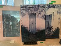 Three art pieces displayed: Monet print with lily pond, French plaques with door and window images