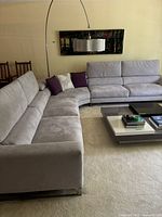 Full assembled three-piece sectional sofa viewed from a corner showing curved center and straight end sections