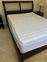 Overall view of bed frame with mattress and footboard