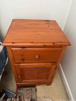 Front view of pine night table showing drawer and cupboard closed