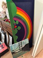 Overview of both wall art pieces leaning against furniture