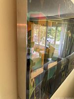 Close side angle showing the thickness and glass-like glossy finish of the wall art painting.