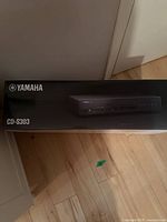 Box of Yamaha CD-S303 CD player showing brand and model