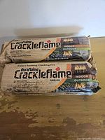 Front view showing both packaged Duraflame Crackleflame firelogs