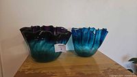Two signed art glass handkerchief bowls on table
