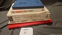 Stack of four cookbooks showing titles and spines