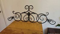 full view of scrollwork wall decor on table