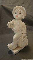 Front view of glossy white Goebel Merry Wanderer figurine