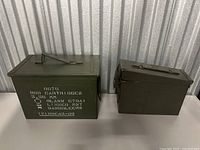 Both military ammo crates shown side by side against a storage unit wall