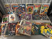 Wide shot showing front covers of all comics and graphic novels spread out