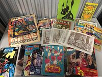 Overview shot of comics and magazines showing the variety of titles and cover art, including Vampirella and Rude Morgue.