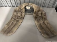Front view of the vintage mink fur wrap scarf laid flat showing the overall shape and beige soft fur texture.