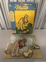 Photo of the Walt Disney Pluto Box with coloring board completed and displayed.