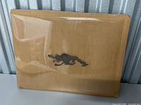 Full view of animation cel mounted on cardboard in protective plastic sleeve