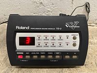 Front view of Roland TD-3 Percussion Sound Module powered on showing numeric display and control buttons