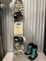 Full view of snowboard with attached bindings and boots