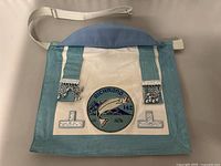 Front view of the vintage Masonic satchel showing embroidered Richmond 142 patch, silver-tone decorative hardware, and straps.