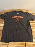 Front view of gray XL Harley-Davidson T-shirt showing orange and white logo text on chest
