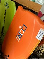 Orange Core brand body board with 2H Jeff Hubbard Signature print, showing a spacious riding surface and vibrant color.