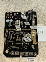 Overview of all jewelry items displayed on a black pad