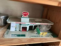 Overall front view of two-level service center with accessories bag on the drive-in floor