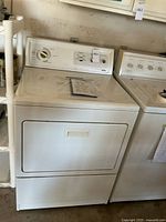 Full view of the white Kenmore Elite gas dryer showing its size and condition.