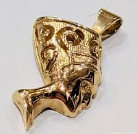 Close-up of pendant front showing sculpted profile and swirl decoration